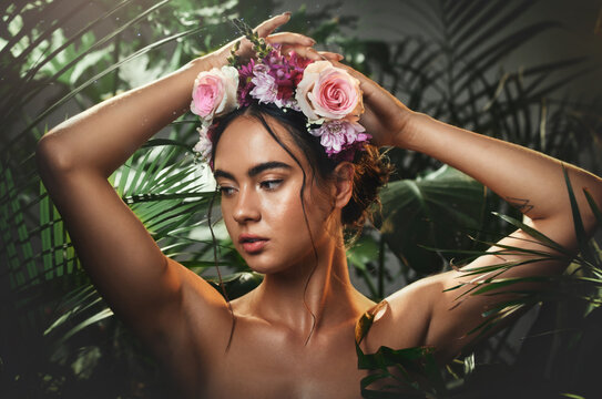 Beauty, forest and face of a woman with a flower crown standing by a tropical leaf background. Cosmetics, skincare and model from Mexico with a wellness skin routine with green plants in nature.