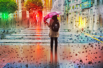 Fototapeta premium people with an umbrella in rainy days in winter season, bilbao, basque country, spain