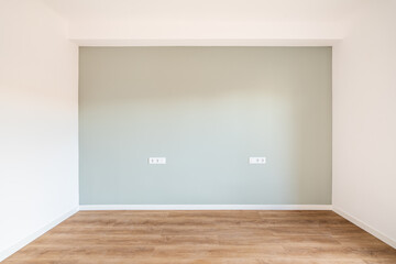 Wide room for a bedroom with a niche wall in a pleasant gray color, focuses on the interior. On the...