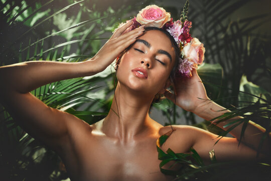 Beauty, skincare and flowers with woman in jungle for tropical cosmetics, spring and natural makeup. Exotic, forest and nature with girl model and rose crown in trees for health, summer and plant
