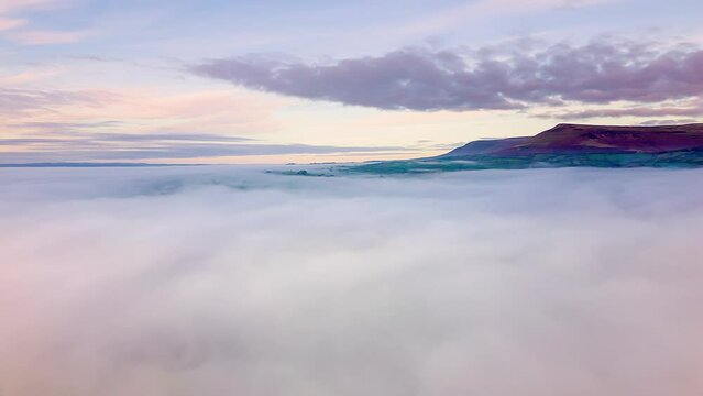 Aerial hyperlapse of fog and cloud moving over a lake