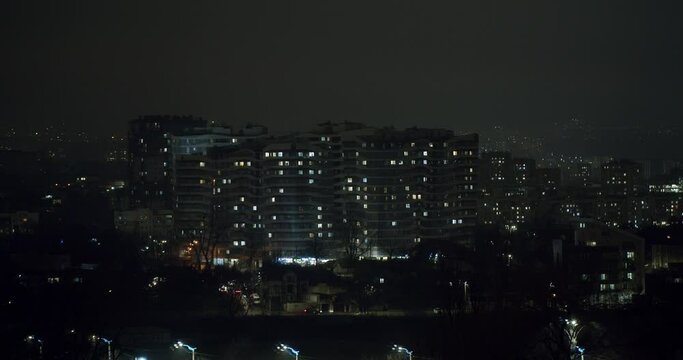 Night time time lapse of apartment buildings and their residents. Residential Neighborhood. View of Residential Building.
