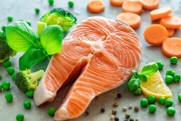Fresh raw salmon steak with vegetables. Ingredients for cooking delicious and healthy food. Diet, dietary food concept