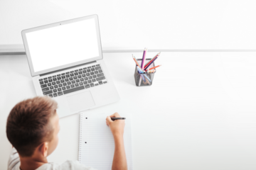 school at home through online homeschooling. the child is sitting at the computer