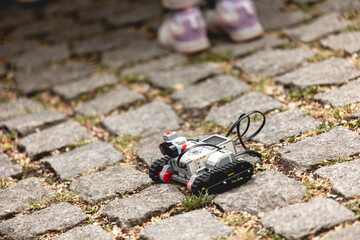 blocks Mindstorms caterpillar rover robot on the granite bricks sidewalk