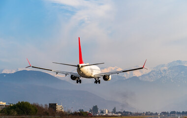 Airplane lands on runway, plane arrives at airport.