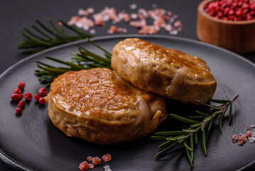 Grilled meatballs with spices and herbs or crepinette on a black plate