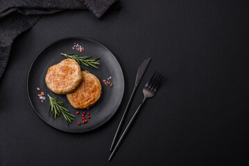Grilled meatballs with spices and herbs or crepinette on a black plate