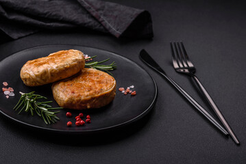 Grilled meatballs with spices and herbs or crepinette on a black plate