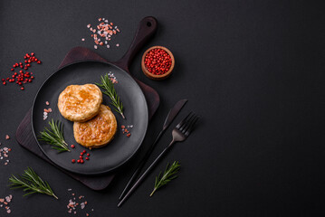 Grilled meatballs with spices and herbs or crepinette on a black plate