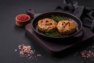 Grilled meatballs with spices and herbs or crepinette on a black plate