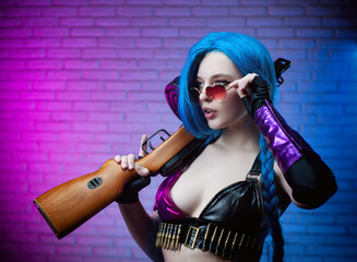 sexy girl in a bright image with a gun in her hands on a neon background