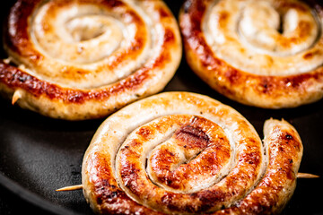 Delicious grilled sausages on a skewer.