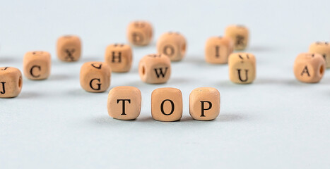 TOP written on a wooden cube , business concept