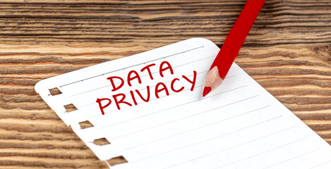 Word DATA PRIVACY on a paper with ped pencil on wooden background