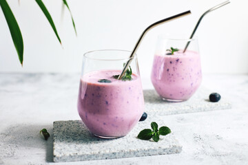 Homemade blueberry smoothie with fresh blueberries. Diets and detox. Healthy refreshing drink, vegan and vegetarian diet food concept