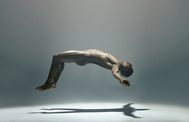 Float, man and naked model in a white background studio for creative art with shadow. Isolated,...