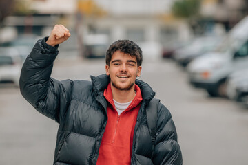 young boy in the street euphoric with joy celebrating success