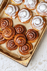 Freshly baked homemade Cinnamon rolls or Cinnamon buns on baking paper
