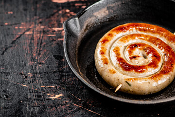 Delicious grilled sausage in a frying pan. 