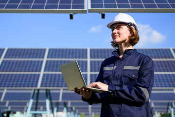 Energy Engineering portrait with solar panel at solar farm. Solar farm with engineer workers...