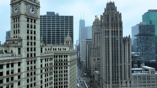 Aerial drone view flying in downtown Chicago loop over Magnificent Mile on cold snowy winter day