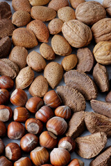 Nuts assortment background. Various nuts with nutshells.