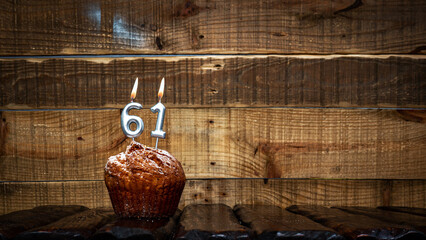 Background happy birthday pie or muffin with candles burning digit number  61. Festive card Happy...