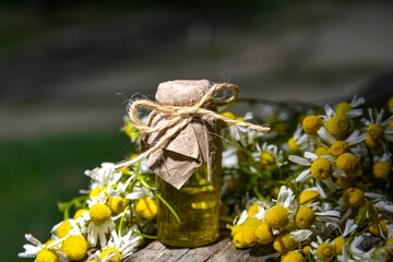 Chamomile essential oil and chamomile flowers