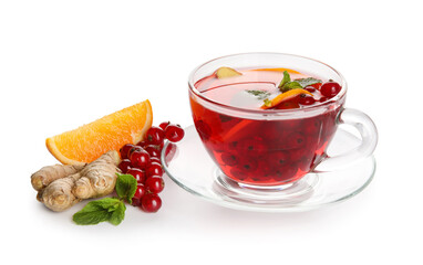 Glass cup of fruit tea with red currant, orange, ginger and mint on white background