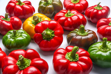 Many fresh bell peppers on white background