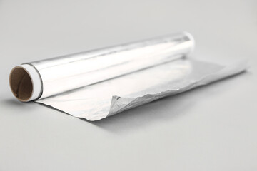 Roll of aluminium foil on grey background