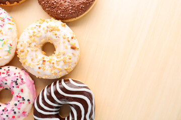 Sweet donuts on wooden background, closeup
