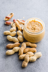 Peanut butter in jar on kitchen table.