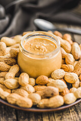 Peanut butter in jar on kitchen table.