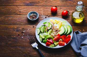 Tuna Salad, Healthy Food, Fresh Salad with Lettuce, Avocado, Cherries, Cucumber and Eggs on a Plate on Wooden Background