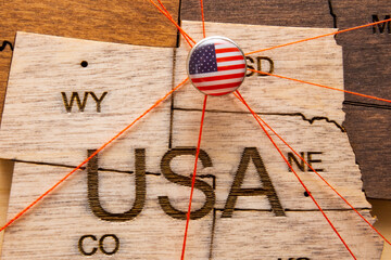 USA flag on the pushpin with red thread showed the paths of movement or areas of influence in the...