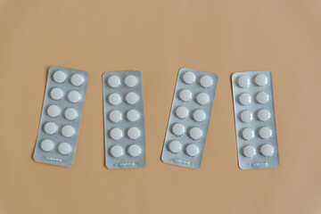 Medical equipment on the beige background. Blisters pills. Medical concept, flat lay.