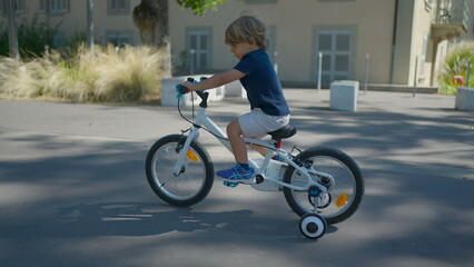 Small child riding bicycle outside little boy rides bike