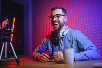 A video blogger records content in his studio. The backstage photo was taken from behind one of the...