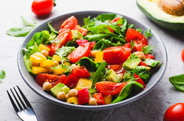 Vegetable Salad, Healthy Eating, Vegetarian Salad with Chickpeas, Avocado, Pepper, Spinach, Cherry Tomatoes in a Bowl