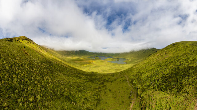 Natural landscape, panoramic view. Beautiful lagoon in the volcanic Caldeirao crater an at Corvo island, Azores, Portugal. Nature and science in this amasing tavel destination.
