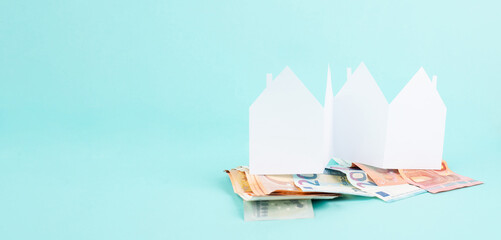 Paper house with Euro banknotes, planning to buy, build or rent a new home, real estate concept,...