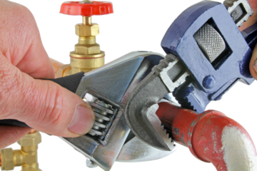Plumber using wrenches adjusting pipework ,transparent png.