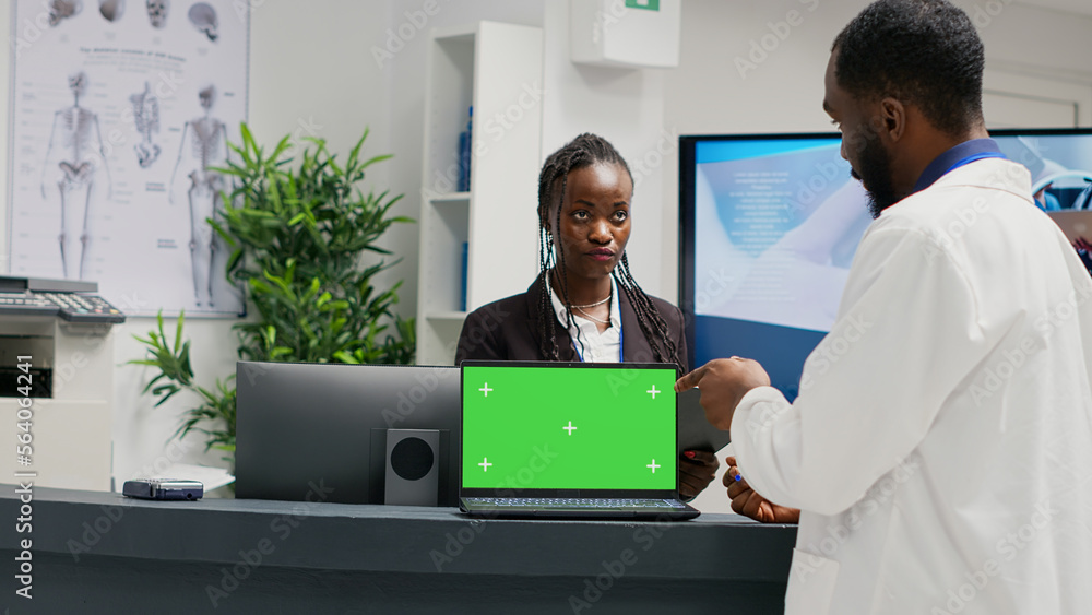 Poster medical specialists working at reception with greenscreen on laptop, using checkup form papers in he