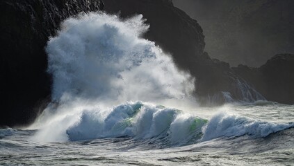 Huge wave crashing against a headland on the south  Washington state coast during a king tide