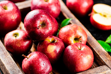 Red apples on a wooden tray. 
