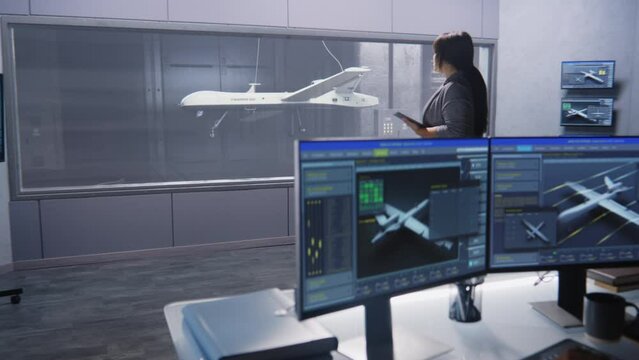 Engineers check aerodynamics of new development drone in laboratory for modern modifications using wind tunnel with steam. Computer system for changing parameters. Concept of manufacturing UCAVs.