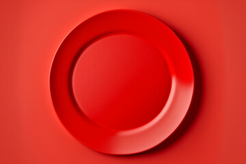 Top view empty blank ceramic round red plate isolated on red background with clipping path.