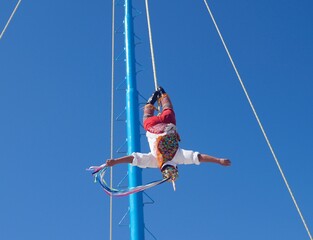 man dangling by feet in mexico